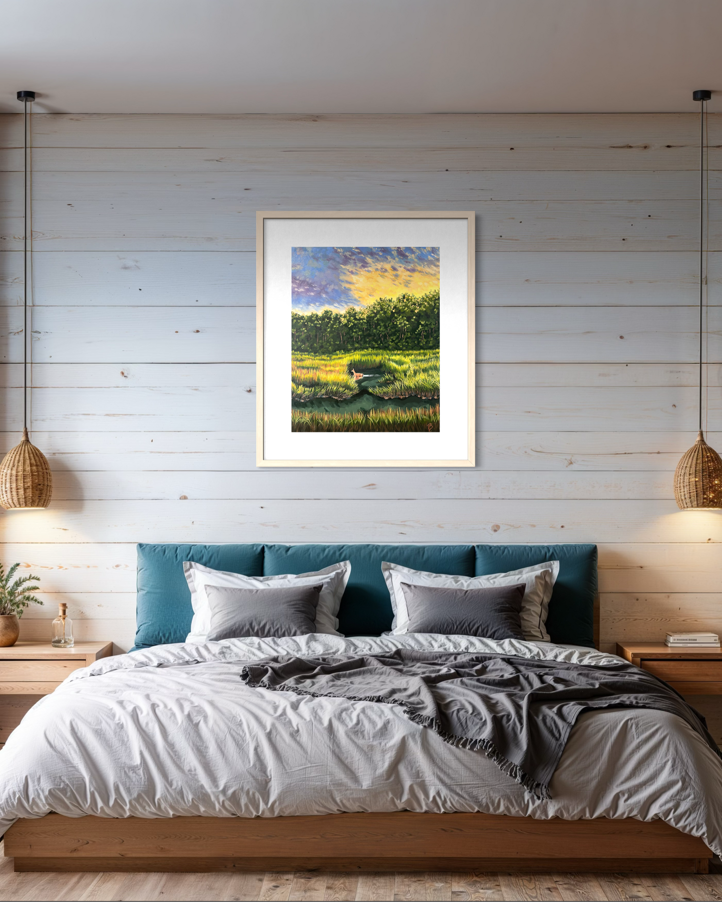 Framed artwork of a coastal march landscape above a bed in a bedroom with wooden walls.