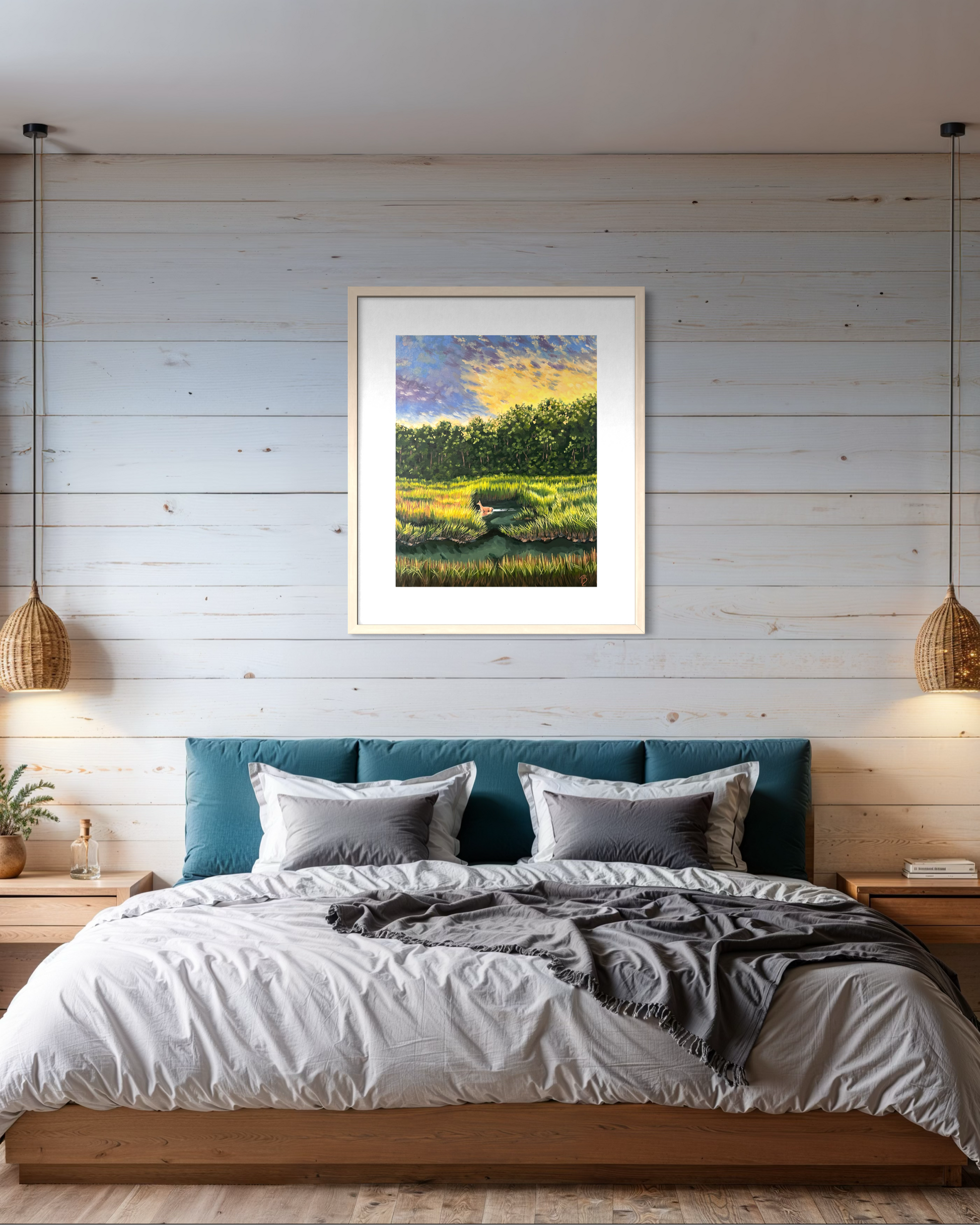 Framed artwork of a coastal march landscape above a bed in a bedroom with wooden walls.