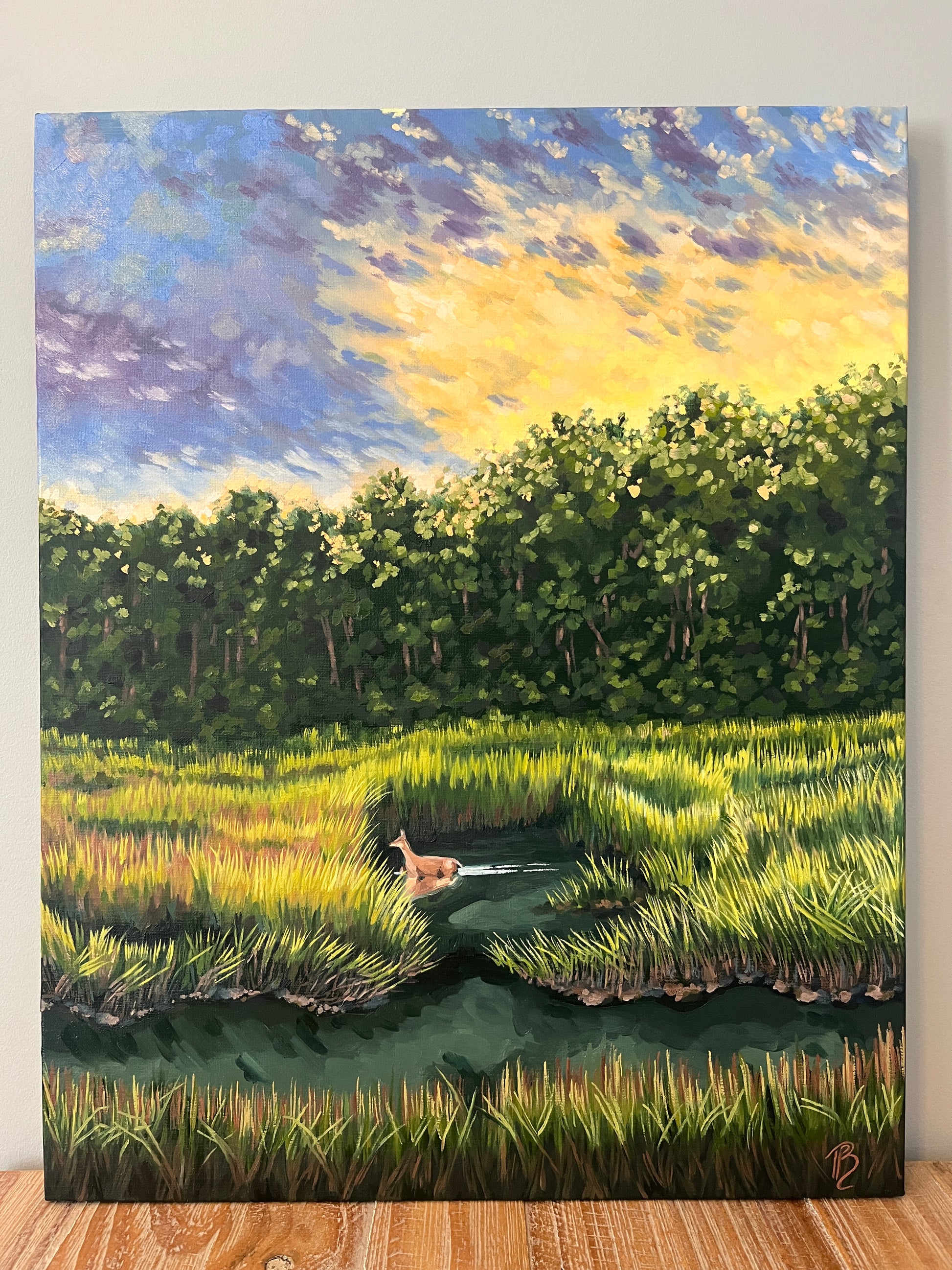 Landscape painting of a marsh at sunset with a deer wading through the water and grasses.