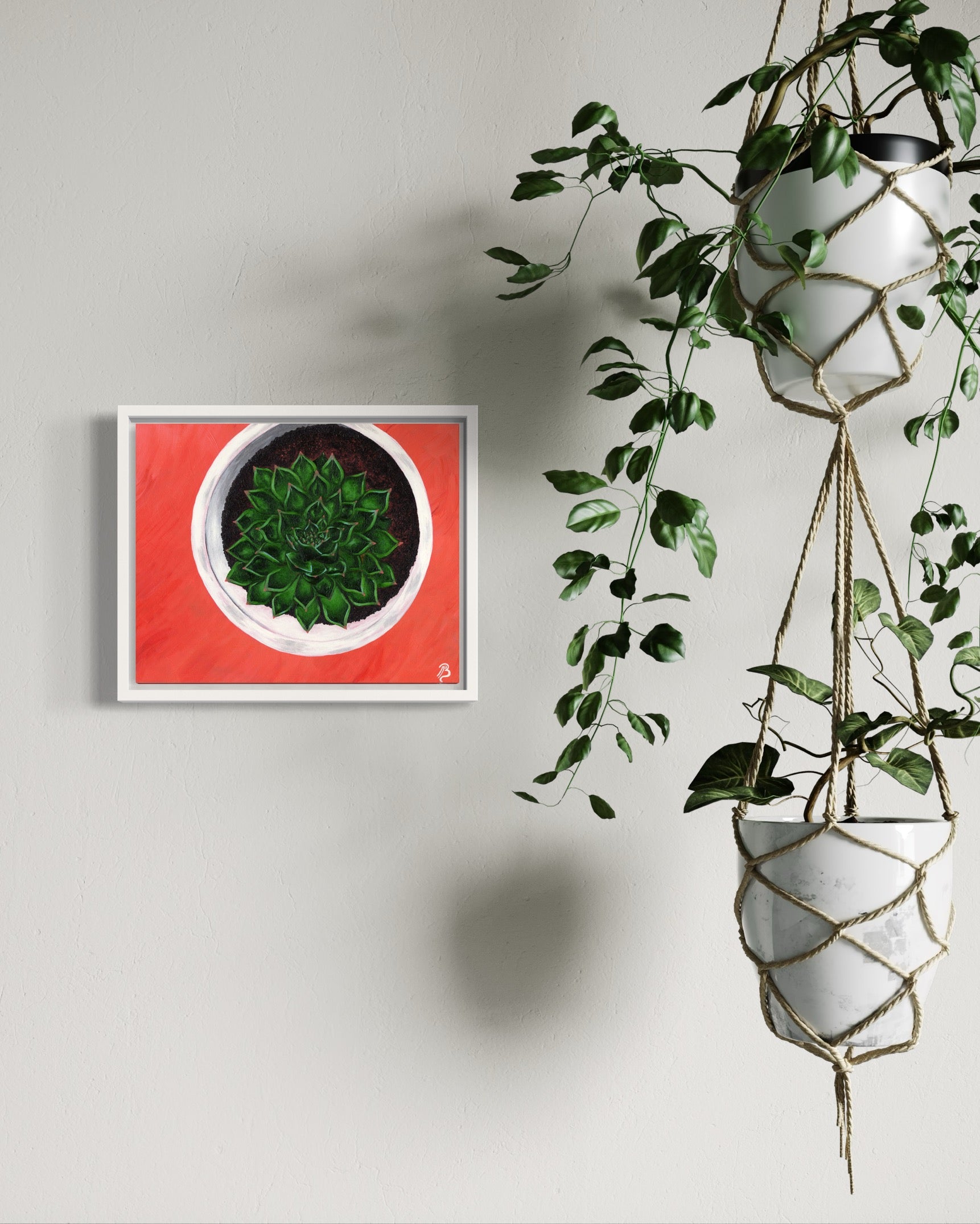 Original framed acrylic painting of a green succulent in a white pot on a coral pink background. The painting is on a cream colored wall with hanging plants nearby.