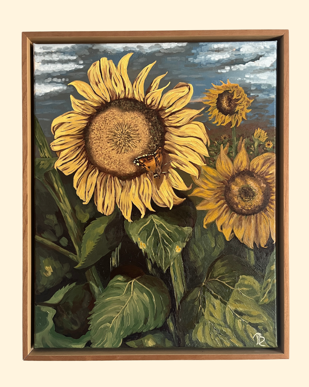 Original oil painting of a sunflower field. The largest yellow sunflower in the foreground has a butterfly resting on the petals. The painting is framed in a warm solid wood floater frame.